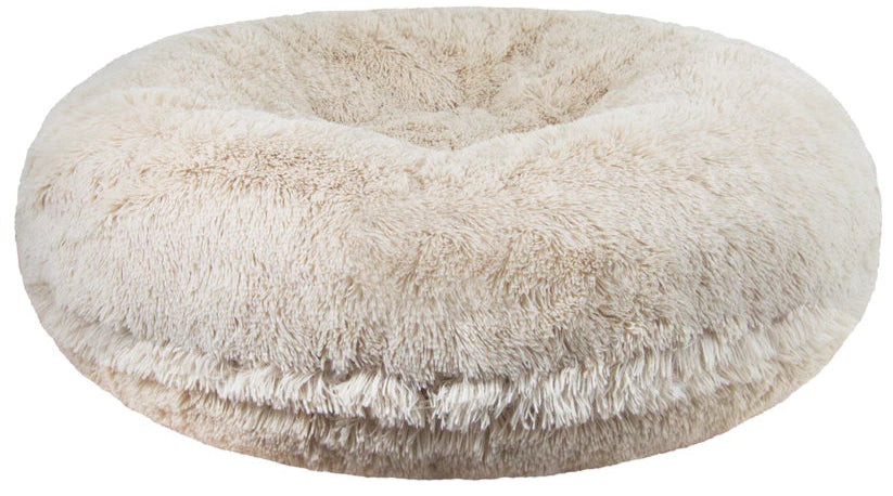 A beige, round, plush pet bed with a soft, fluffy texture.